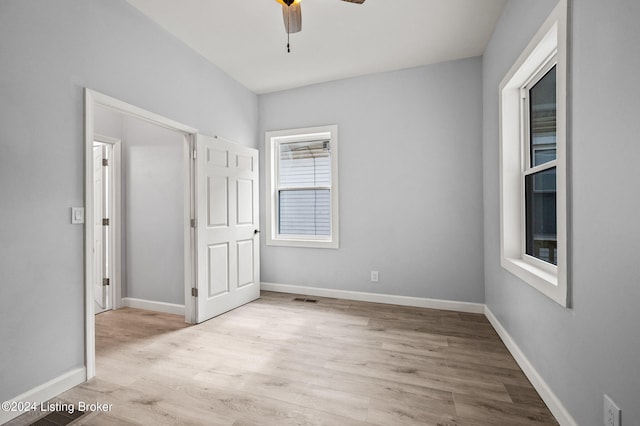 unfurnished bedroom featuring ceiling fan and light wood-type flooring