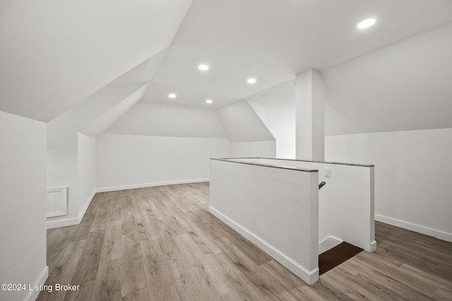 bonus room featuring light hardwood / wood-style flooring and lofted ceiling