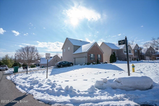 snow covered property featuring a garage