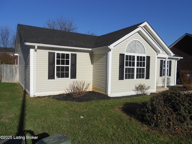 view of side of home featuring a yard