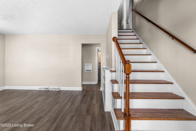 staircase with wood-type flooring