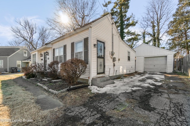 view of front of property with a garage and an outbuilding