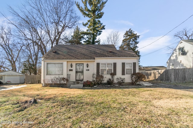 view of front of home featuring an outbuilding, a garage, and a front lawn