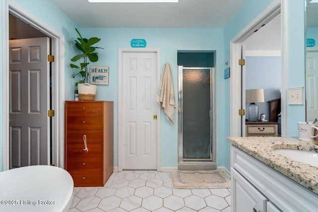 bathroom with walk in shower and vanity