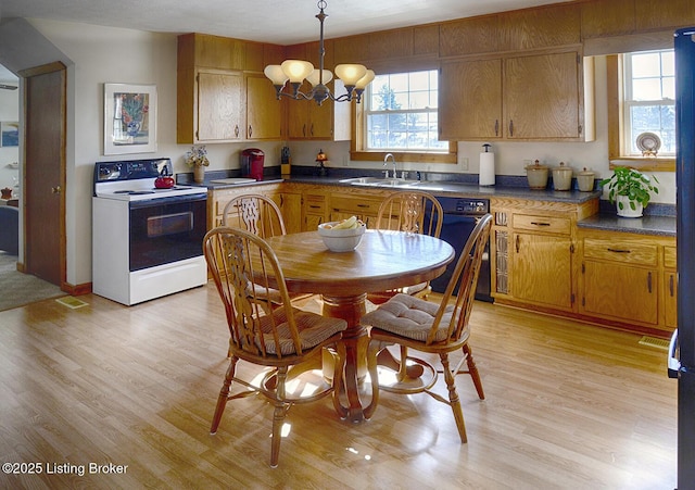 kitchen featuring sink, light wood-type flooring, a notable chandelier, and white range with electric cooktop