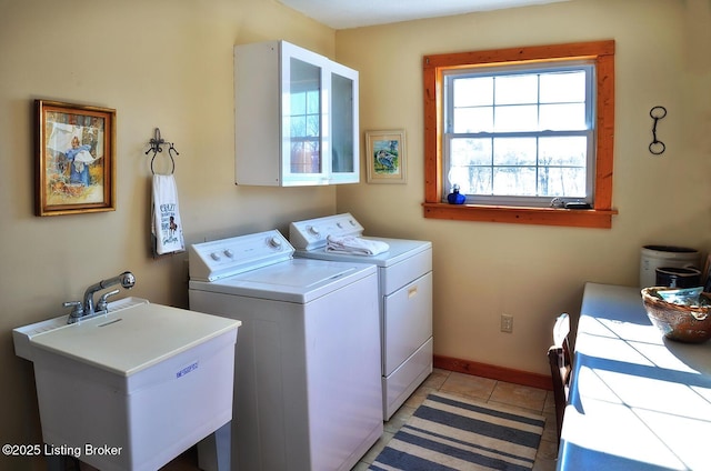 laundry room featuring washer and dryer, sink, and light tile patterned floors