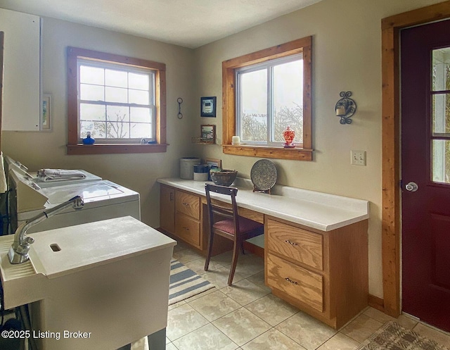 tiled home office with sink, built in desk, and washing machine and clothes dryer