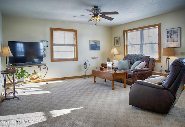 carpeted living room with ceiling fan