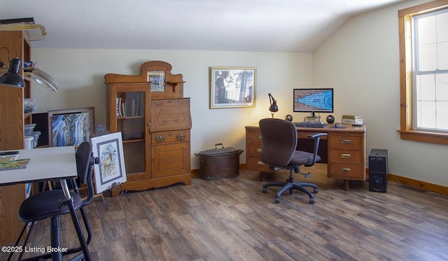 home office with vaulted ceiling and dark hardwood / wood-style flooring