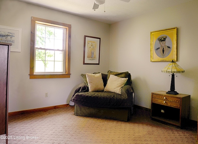 sitting room featuring ceiling fan and carpet flooring