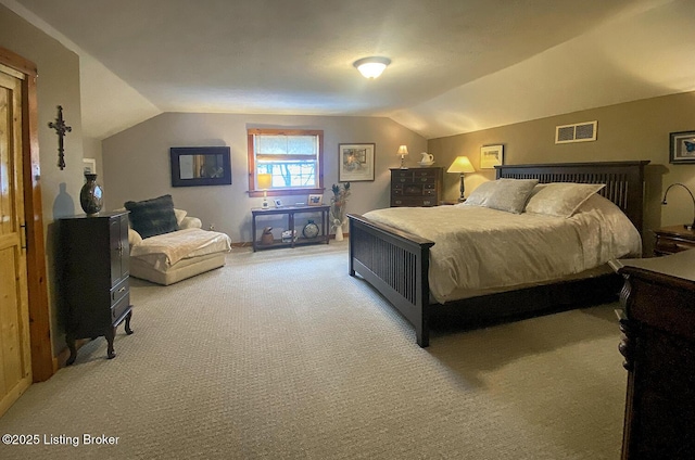 carpeted bedroom with lofted ceiling