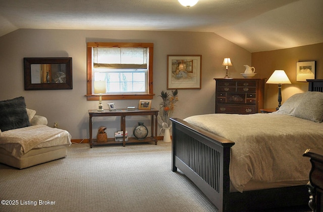 carpeted bedroom featuring lofted ceiling