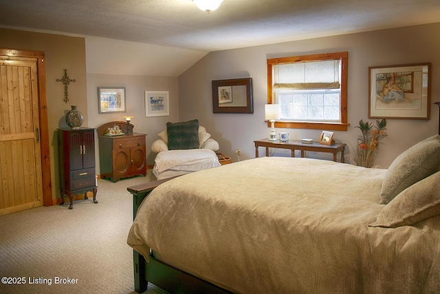 bedroom featuring a textured ceiling, carpet, and lofted ceiling