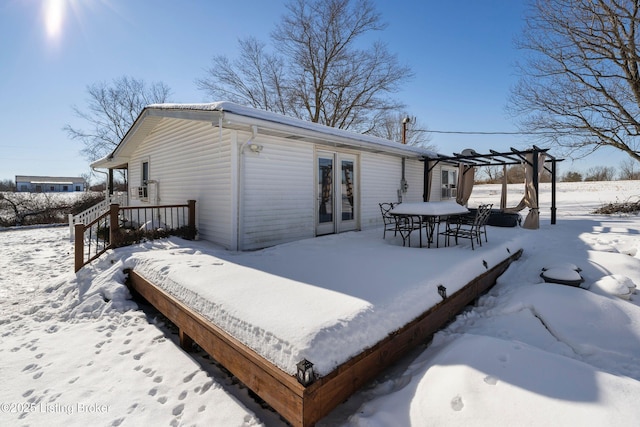 snow covered house with a pergola