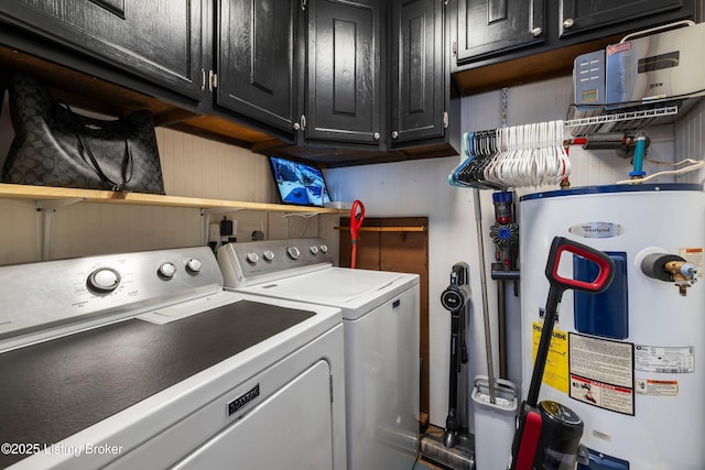 laundry room with washer and dryer, cabinets, and water heater