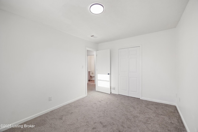 unfurnished bedroom with carpet and a closet