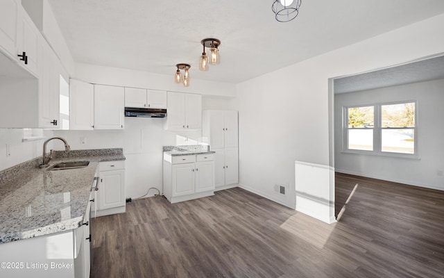 kitchen featuring white cabinetry, dark hardwood / wood-style flooring, hanging light fixtures, and sink