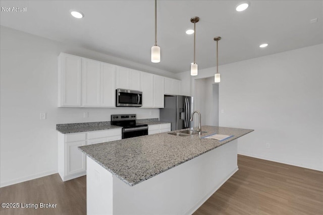 kitchen with decorative light fixtures, stainless steel appliances, light hardwood / wood-style floors, and a center island with sink