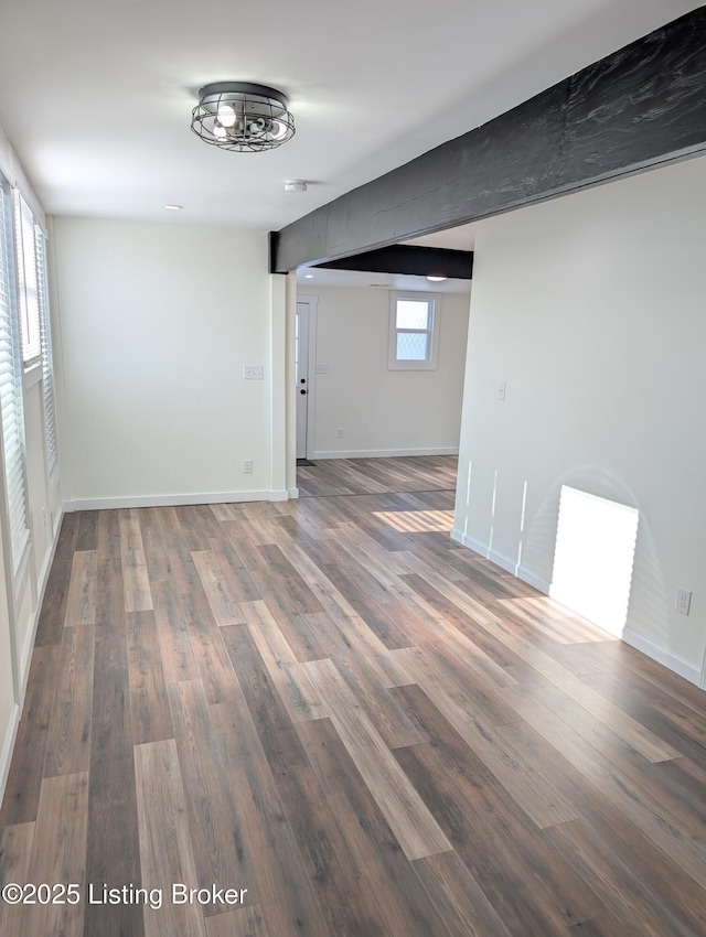 unfurnished room with a wealth of natural light and dark hardwood / wood-style floors