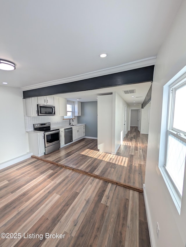 unfurnished living room with sink and dark hardwood / wood-style flooring