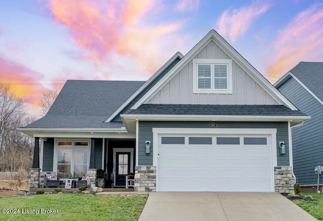 craftsman house featuring a garage, a porch, and a lawn