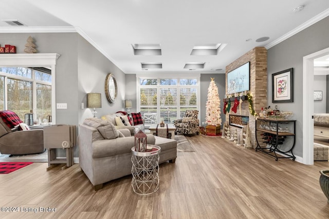 living room featuring light hardwood / wood-style floors and crown molding