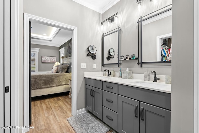 bathroom with ornamental molding, vanity, and hardwood / wood-style floors