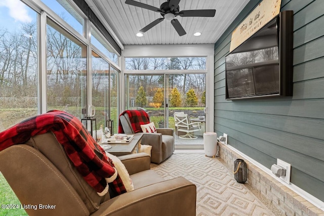 sunroom featuring ceiling fan and plenty of natural light