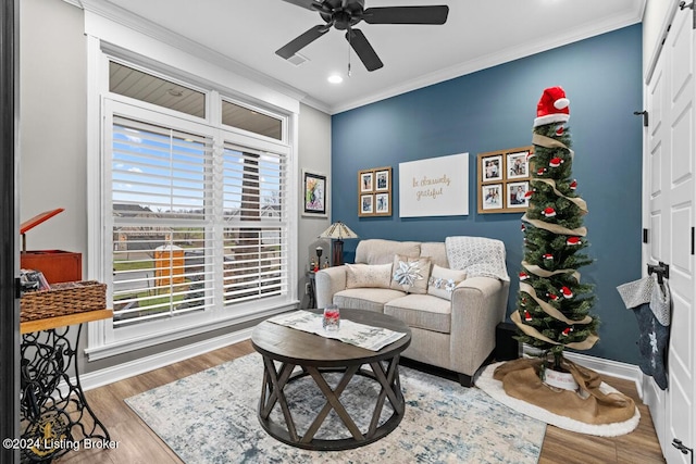 living room with ceiling fan, crown molding, and wood-type flooring