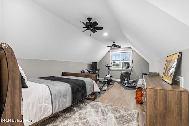 bedroom with vaulted ceiling, ceiling fan, and wood-type flooring