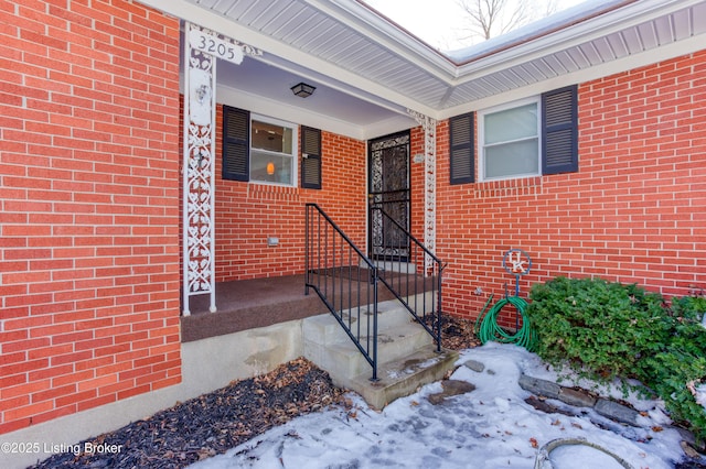 view of snow covered property entrance