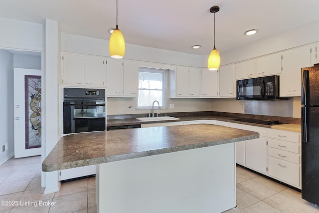 kitchen featuring decorative light fixtures, sink, white cabinetry, and black appliances