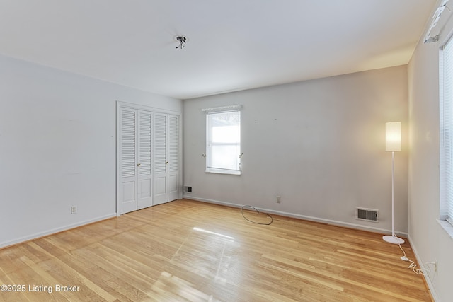 unfurnished bedroom featuring a closet and light hardwood / wood-style flooring