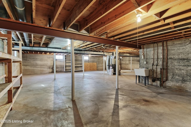 basement featuring heating unit and sink