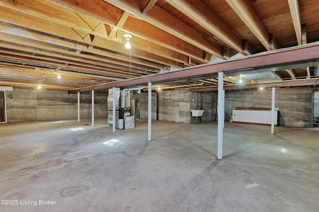 basement with sink and heating unit