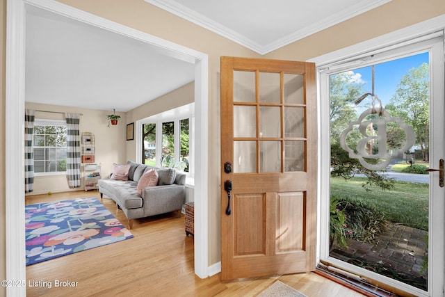 doorway to outside featuring ornamental molding and light hardwood / wood-style flooring