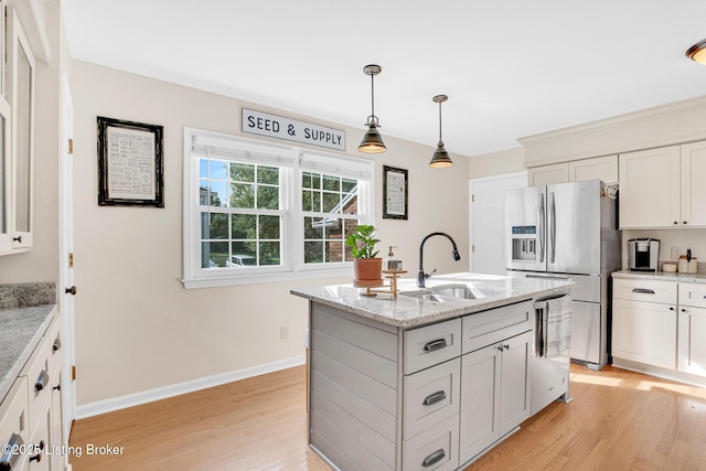 kitchen featuring stainless steel refrigerator with ice dispenser, white cabinetry, light stone counters, and light hardwood / wood-style flooring