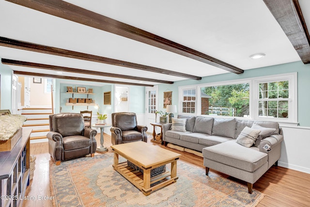 living room featuring beamed ceiling and wood-type flooring