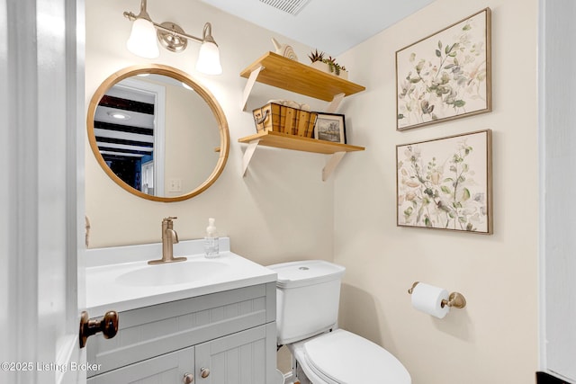 bathroom featuring toilet and vanity