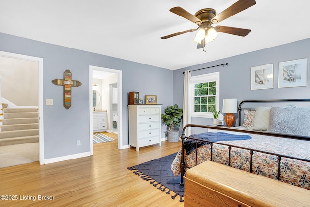 bedroom featuring ceiling fan, light wood-type flooring, and connected bathroom