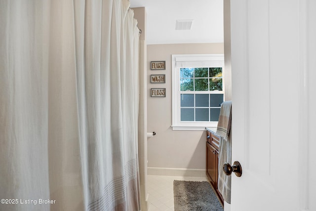 bathroom featuring walk in shower and vanity