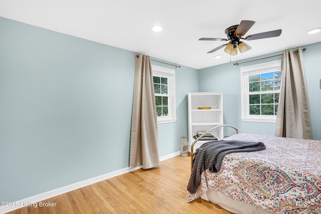 bedroom with ceiling fan and light hardwood / wood-style flooring