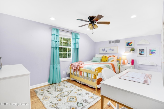 bedroom with ceiling fan, lofted ceiling, and hardwood / wood-style flooring