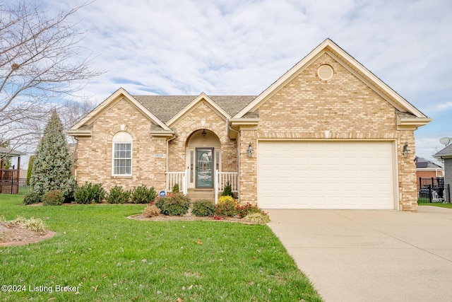 view of property featuring a front lawn and a garage