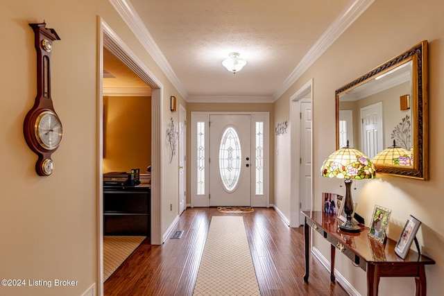 entrance foyer with a textured ceiling, ornamental molding, and dark hardwood / wood-style floors