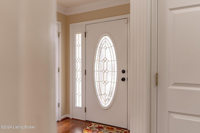 foyer featuring light wood-type flooring and crown molding