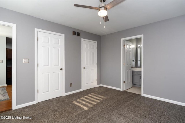 unfurnished bedroom with ceiling fan, carpet floors, and ensuite bath