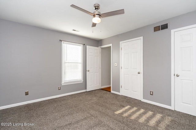 unfurnished bedroom with dark carpet and ceiling fan