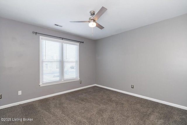 spare room featuring carpet and ceiling fan