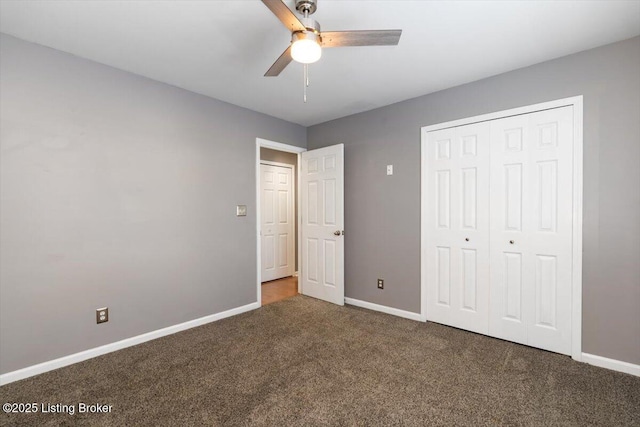 unfurnished bedroom featuring ceiling fan, a closet, and dark colored carpet